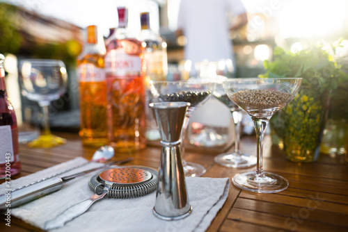 many different ingredients on the bartender's table for making alcoholic cocktails