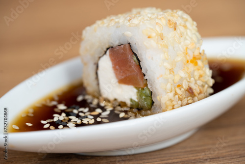 delicious traditional Japanese sushi and rolls on a plate in soy sauce