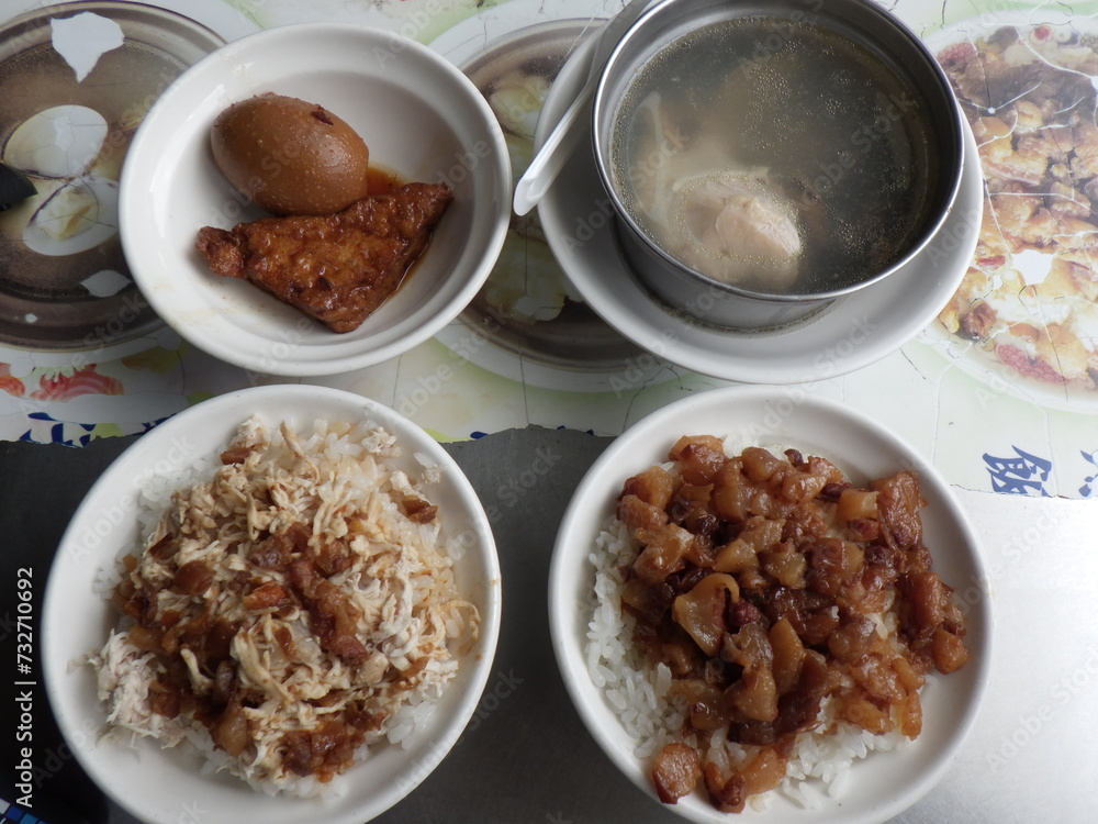 KAOHSIUNG, TAIWAN - January 1, 2024 :Chicken rice, pork rice, soup, and side dishes that I ate in Kaohsiung, Taiwan KAOHSIUNG, TAIWAN - January 1, 2024 :Chicken rice, pork rice, soup, and side dishes that I ate in Kaohsiung, Taiwan