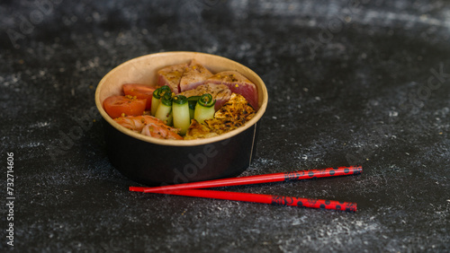 Seafood salad served on a beautiful plate. Salad with king prawns and prosciutto.