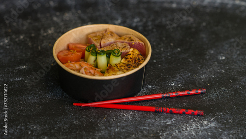 Seafood salad served on a beautiful plate. Salad with king prawns and prosciutto.