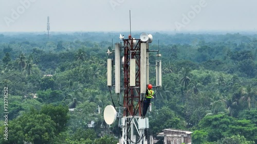 Technician climbing a network tower to fix it. Skilled work that technicians do to keep our communication networks running smoothly