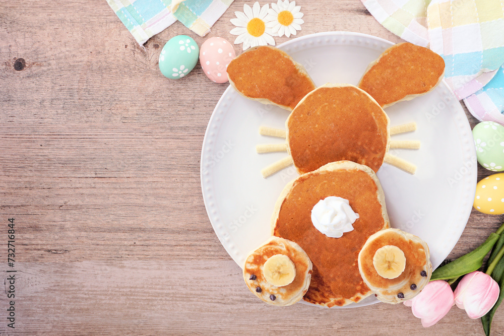 Cute Easter Bunny pancakes on a white plate. Above view table scene over a wood background. Cute Easter Bunny pancakes on a white plate. Above view table scene over a wood background.