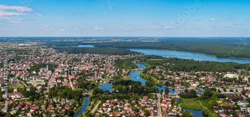 Fototapeta Naklejka Na Ścianę i Meble -  Augustow city by Netta river and Necko lake aerial landscape under blue sky