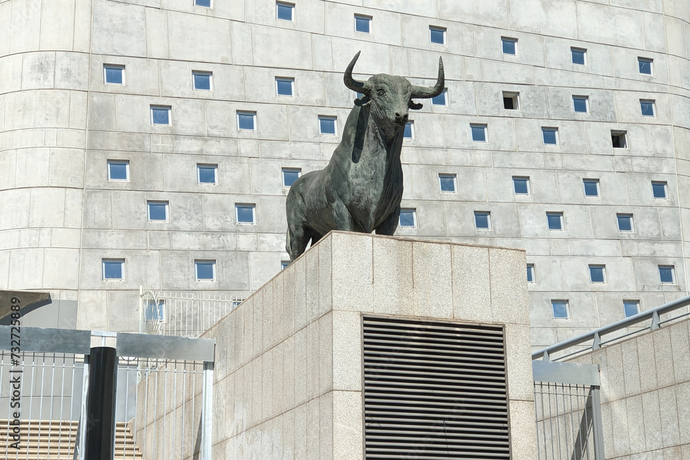 Naklejka premium Statue of a bull on the facade of the building of bullring in Madrid. The bull is an iconic symbol of Spain