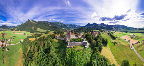 Switzerland travel and landmarks. scenic medieval village and castle Gruyere. canton Fribourg. Aerial panoramic drone view photo