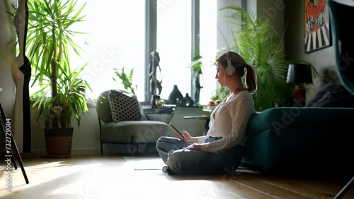 Female nurse or doctor enjoying free time at home after work, listening meditation relaxing music. Work-life balance for healthcare worker. photo
