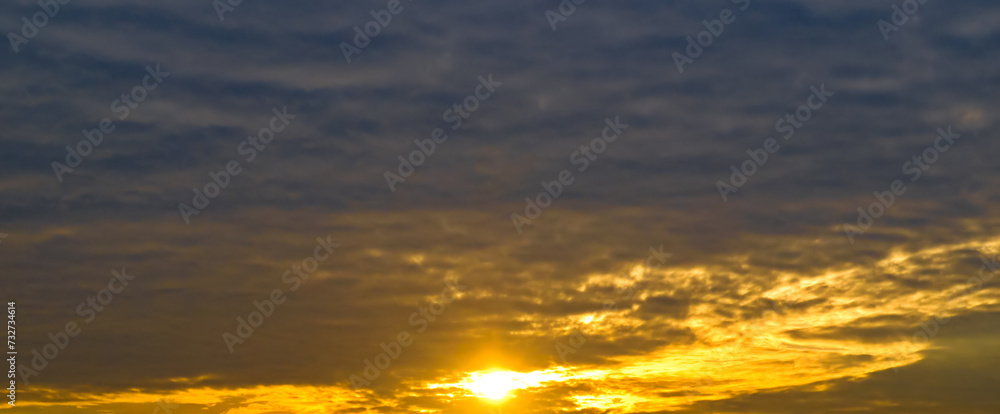 sky with cirrus clouds and bright sunrise. Wide photo.