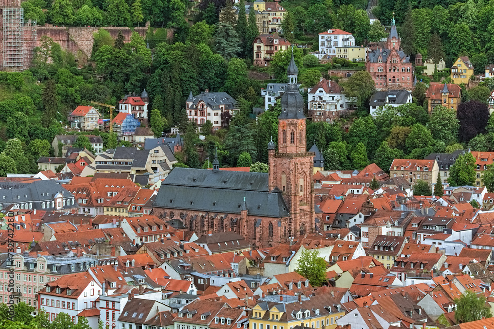 Church of the Holy Spirit in Heidelberg Old Town, Germany. High angle view from a hill at the opposite bank of Neckar river. The church was constructed between 1398 and 1515.