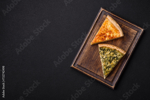 Delicious crispy quiche cut into slices with cheese, broccoli, tomatoes