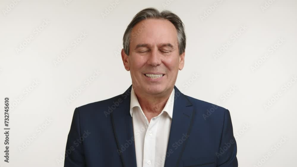 Elegant businessman in business attire smiling joyfully and nodding in approval. He agrees with what he sees and endorses the decision. White background. Camera 8K RAW. Elegant businessman in business attire smiling joyfully and nodding in approval. He agrees with what he sees and endorses the decision. White background. Camera 8K RAW.