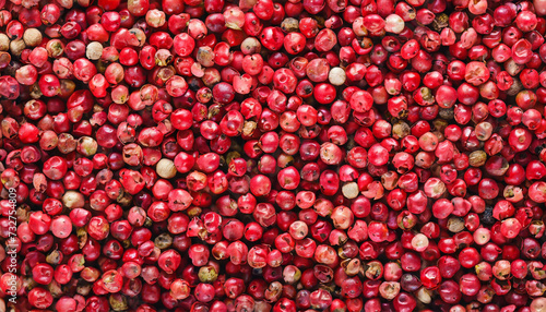 Pink peppercorns background, top view. photo