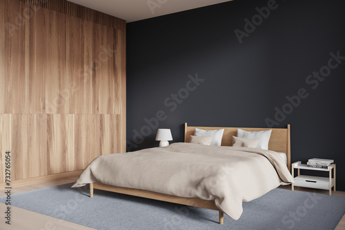 Stylish hotel bedroom interior with bed, nightstand and mock up wall photo