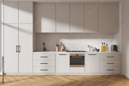 Stylish home kitchen interior with stove, oven and kitchenware on counter