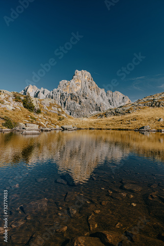 Beautiful reflection in a hidden mountain lake in the Alps