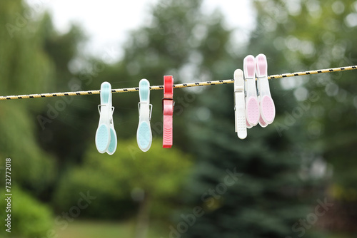 Clothespins on a clothesline and a garden background
