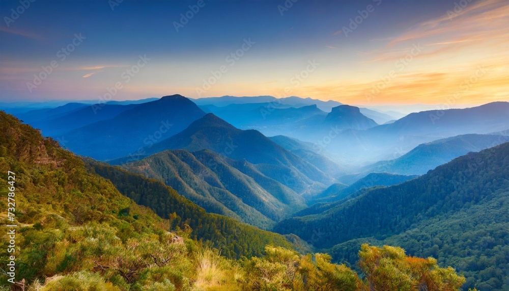 beautiful layered blue mountains transitioning into the sunset horizontal