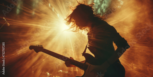 A dynamic image of a person playing guitar, captured mid-performance with pas...