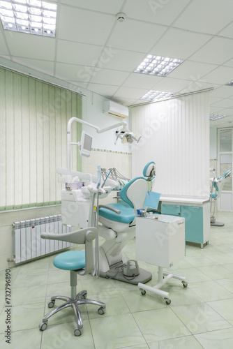 Metal dental chair in blue and white color inside the dental office
