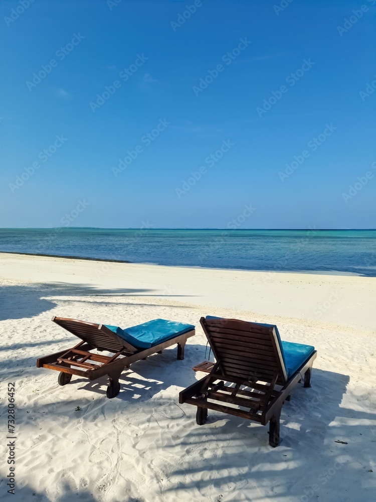 Beach loungers on the dream white beach of the Maldives.