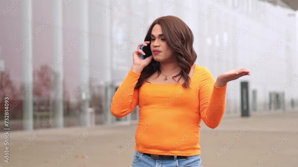 Transsexual woman arguing in her cellphone. She is frustrated and gesturing with hand. Slow-motion. Transsexual woman arguing in her cellphone. She is frustrated and gesturing with hand. Slow-motion.