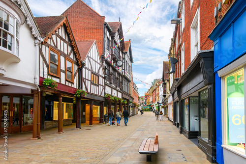 Fototapeta Naklejka Na Ścianę i Meble -  Picturesque half timber frame buildings full of shops and cafes on the popular and touristic High Street in the medieval old town of Winchester, England, UK.