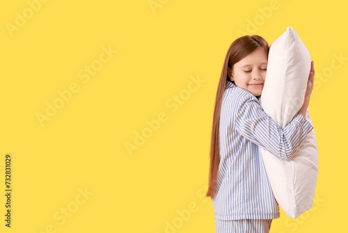 Little girl hugging pillow ...
