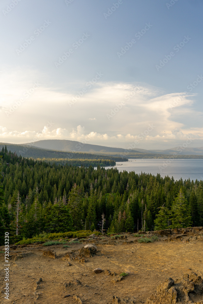 lake with forest and mountains during sunset