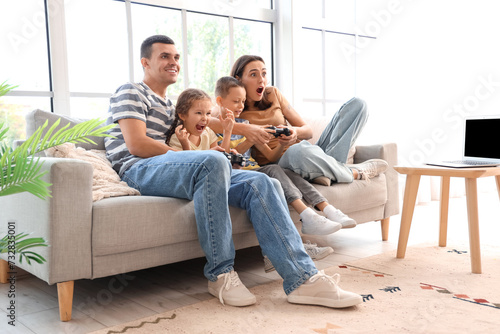 Happy family playing video game at home
