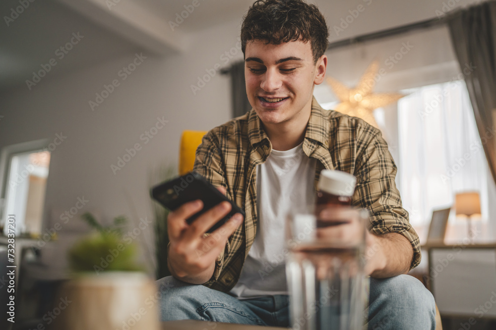 One man hold medicine drugs bottle pills read label on mobile phone One man hold medicine drugs bottle pills read label on mobile phone