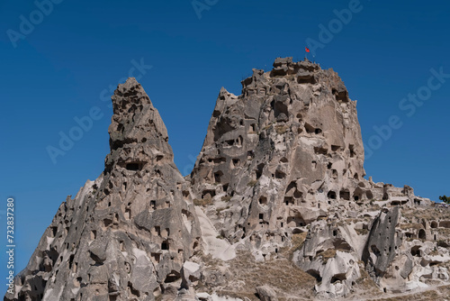 Utichar rock hewn castle in Cappadocia, Anatolia Turkey on a summer day with blue sky