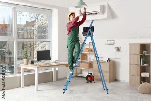 Male electrician on steplad...