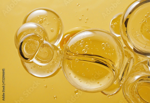 Obraz na płótnie Golden yellow bubble oil or serum isolated on yellow background w salonie