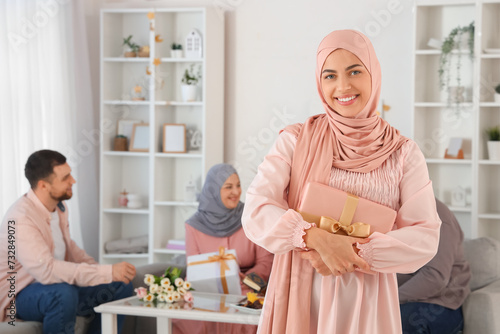Young Muslim woman with gif...