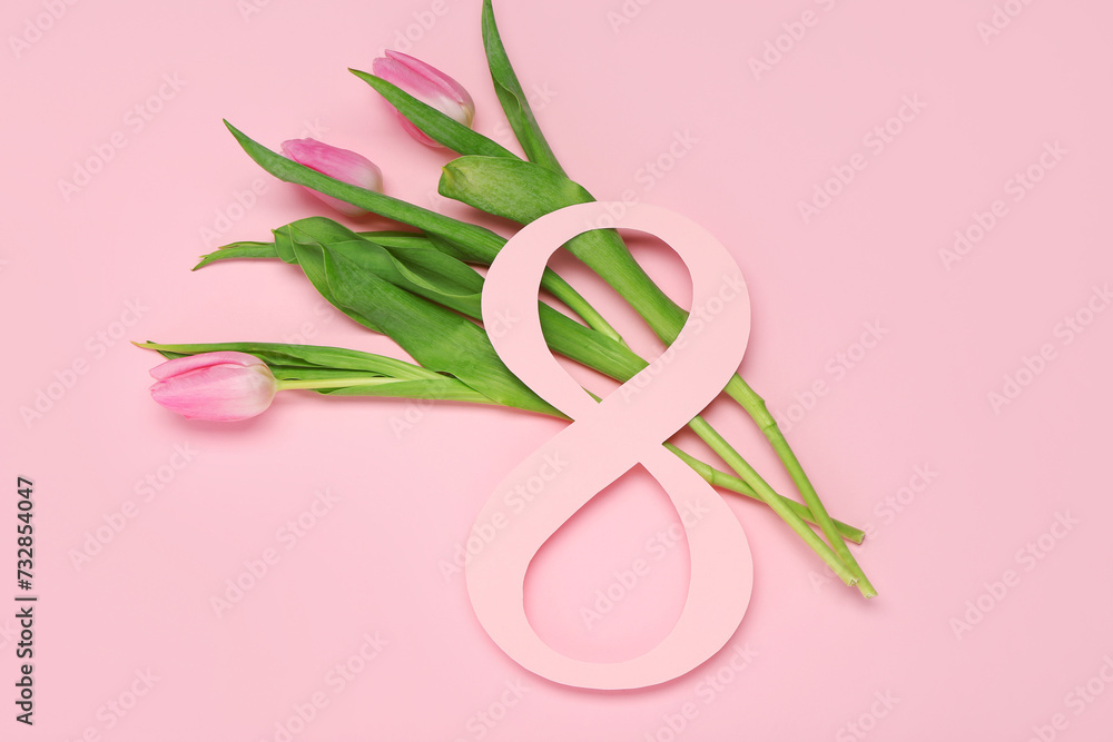 Figure 8 made of paper and beautiful tulips on pink background. International Women's Day Figure 8 made of paper and beautiful tulips on pink background. International Women's Day