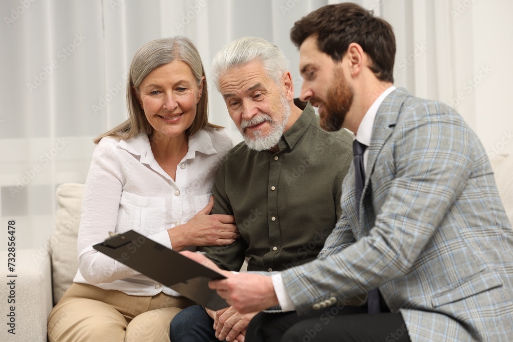 Notary consulting senior couple about Last Will and Testament in office Notary consulting senior couple about Last Will and Testament in office