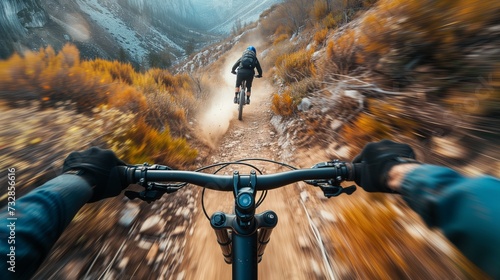 Mountain biker navigating a challenging trail, with dirt and rocks flying, capturing the thrill of the ride. photo