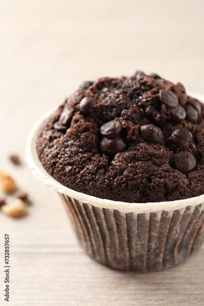 Delicious chocolate muffin on white wooden table, closeup Delicious chocolate muffin on white wooden table, closeup