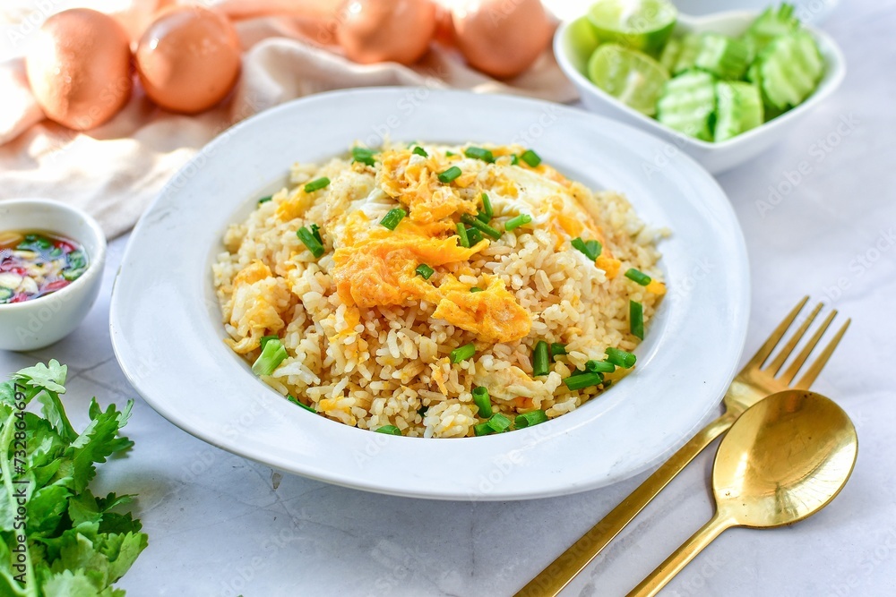 Fried rice with egg on white plate , Thai call kaw pad kai, thai food , asian food, home cooked