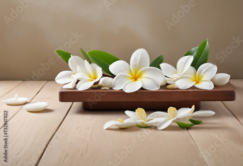 Tropical spa relaxation  Tranquil frangipani flowers on wooden table with white background