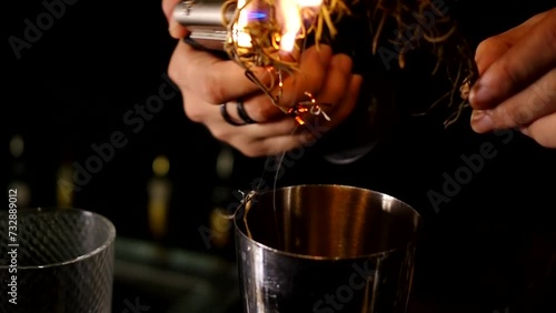 bartender burning rosemary with butane torch rosemary-smoked negroni barman making cocktail video photo