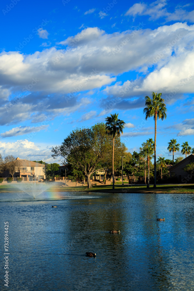 Shining rainbow in a middle of North lake fountain at Dos Lagos park, Glendale, Arizona