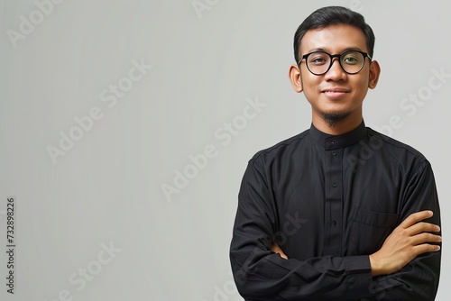 Asian Muslim man wearing glasses smiling to give greeting during Ramadan and Eid Al Fitr celebration over white background, realistic, HD, copy space - generative ai