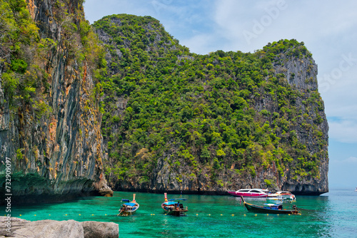 KOH PHI PHI, THAILAND - MARCH 11 2022: Motor boats on turquoise water of Maya Bay lagoon on MARCH 11, 2022 in Koh Phi Phi island, Thailand. This was extremely quiet due to the Covid 19 pandemic. © Scotts Travel Photos