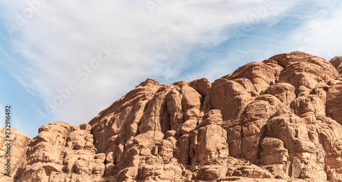 The beautifully shaped peaks of high mountain ranges in red desert of the Wadi Rum near Amman in Jordan