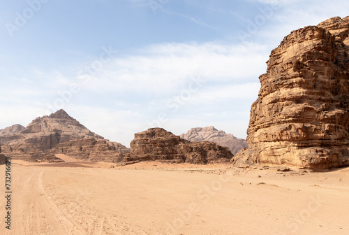 Tread marks from off road vehicle tires in the red desert surrounded by the high mountains in the the Wadi Rum desert near Amman in Jordan
