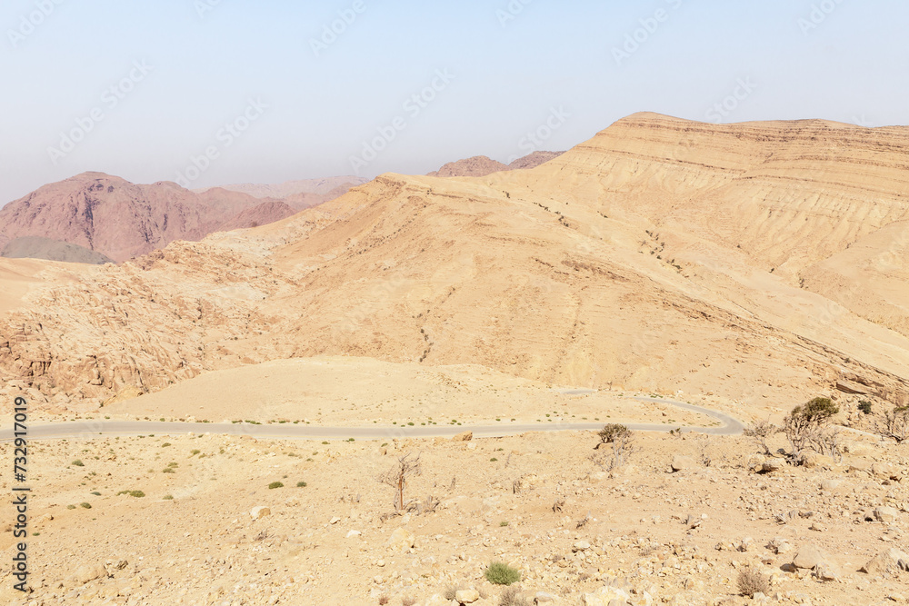 View of low mountains in gorge Wadi Al Ghuwayr or An Nakhil and wadi Al Dathneh from the road leading to it near Amman in Jordan