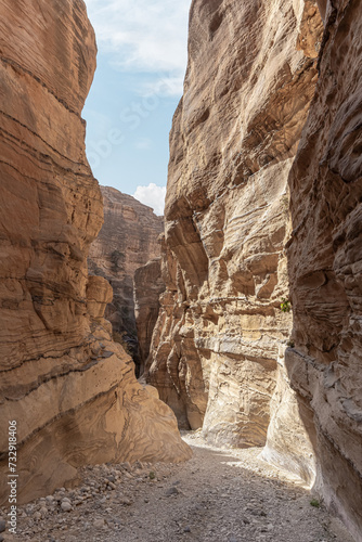 High mountains on both sides of tourist route of the gorge Wadi Al Ghuwayr or An Nakhil and the wadi Al Dathneh near Amman in Jordan