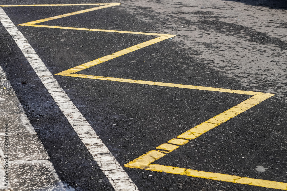 Yellow and white zig zag road line markings generally provide motorists with instructions that stopping on parking on the zig zag line area is prohibited.