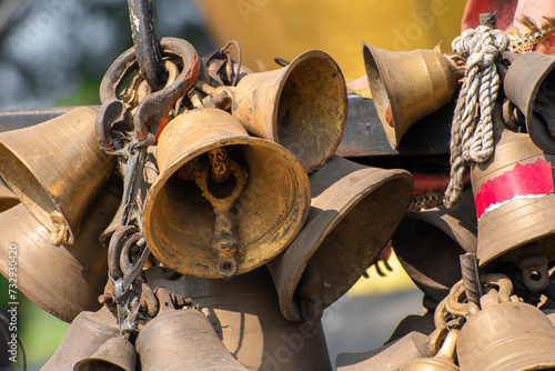 Ringing bells of a religious temple. Brass praying bells hanging on old temple